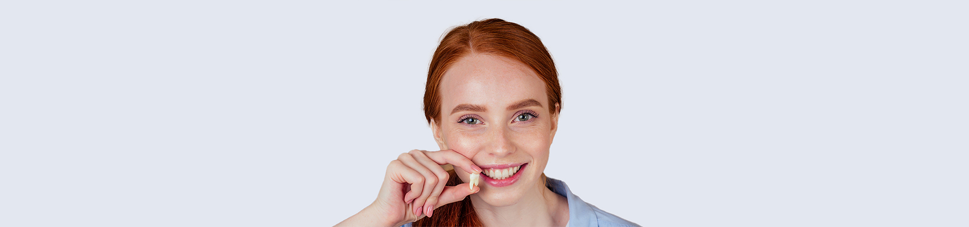 A dentist performing a tooth extraction on a patient in a clinical setting, with dental tools and equipment visible at New Smile Dentistry.