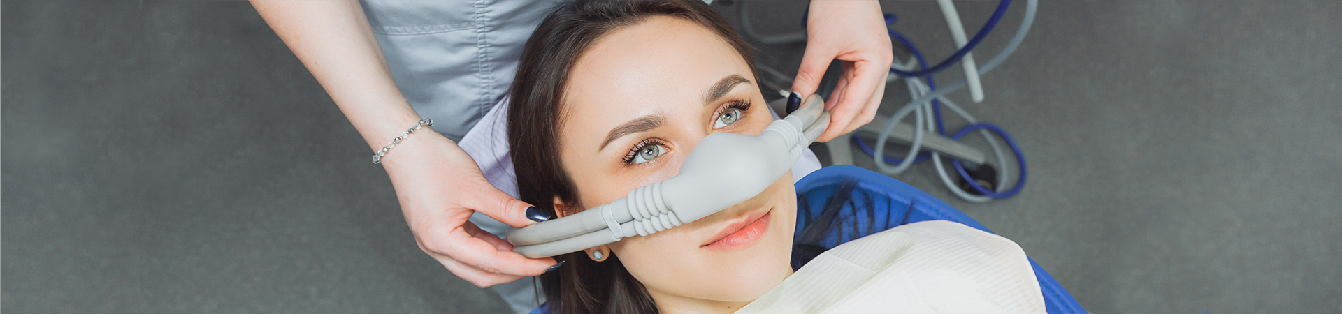 A dentist prepares to sedate a patient in a bright, modern dental office, ensuring comfort and care at New Smile Dentistry.